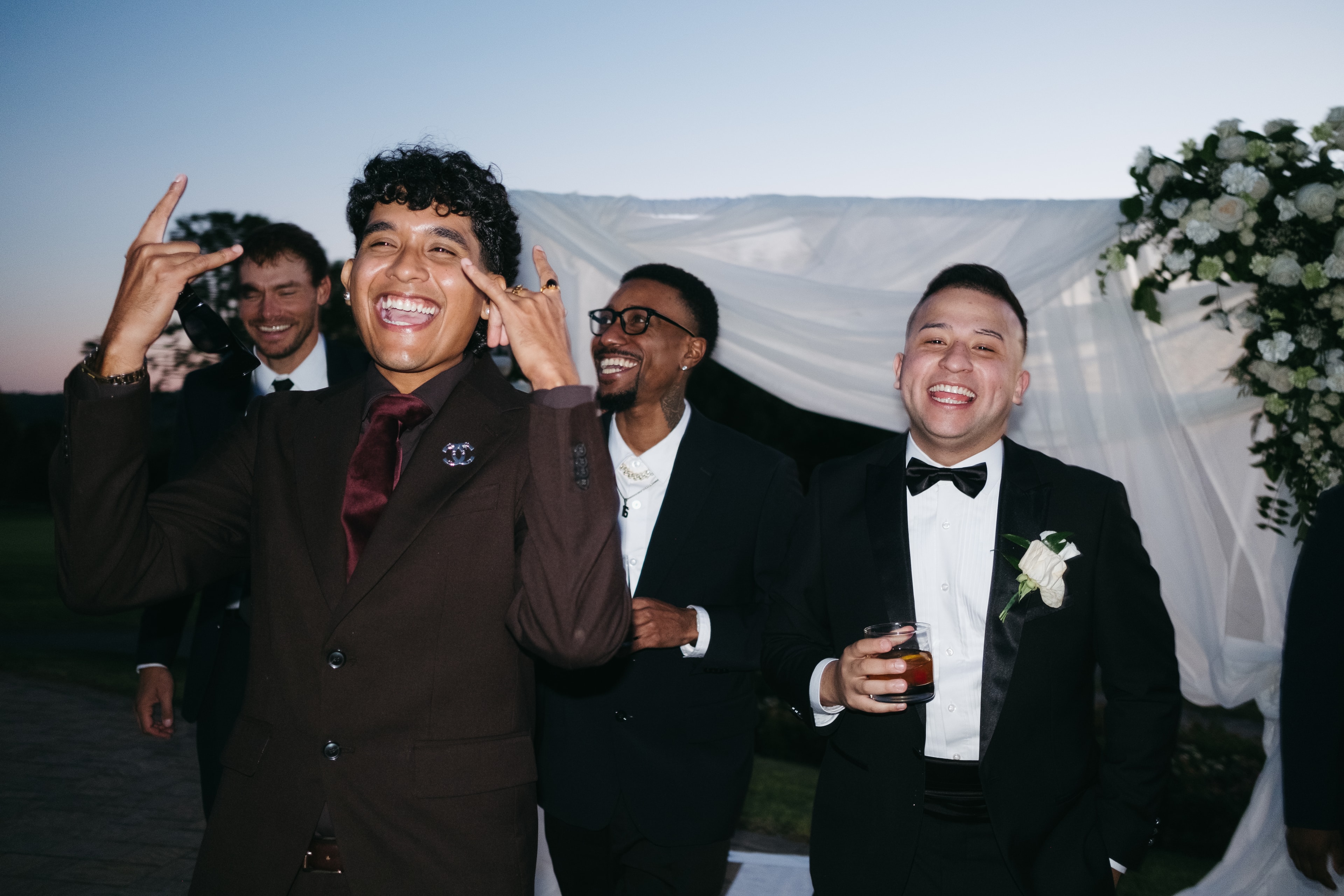 Group holding shot glasses with cherries